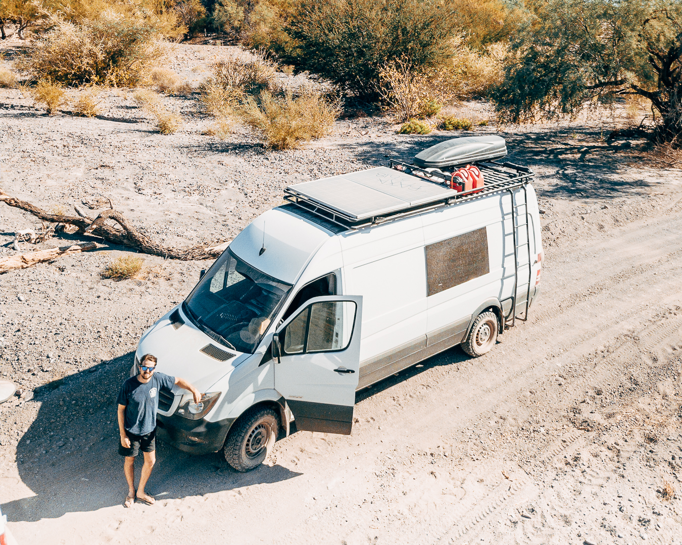 Scott and the van in sandy terrain.