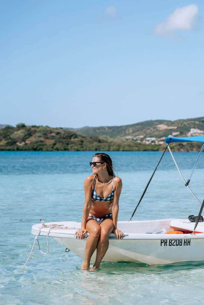 woman sitting on edge of boat in la parguera puerto rico
